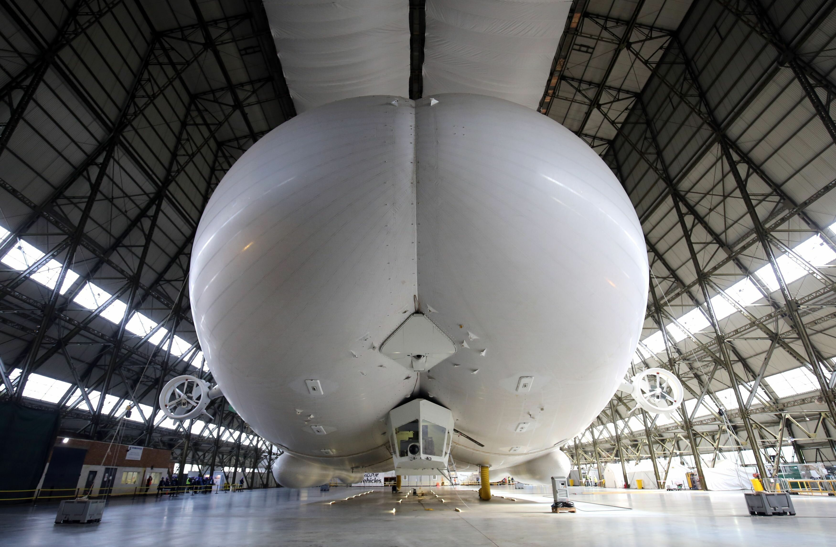 The Airlander 10 airship, the world's largest aircraft, is unveiled for the first time since being fully assembled at Cardington hanger in Bedfordshire, England, Monday March 21, 2016. (Chris Radburn/PA via AP) UNITED KINGDOM OUT NO SALES NO ARCHIVE